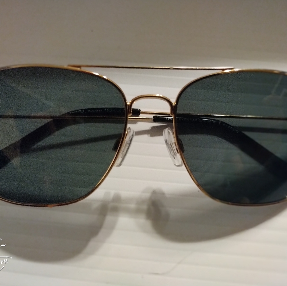 INVU Sun glasses,gold frame , polarized lenses with a fairly dark shade.